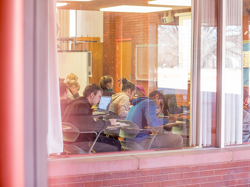 Students seen through a window in class