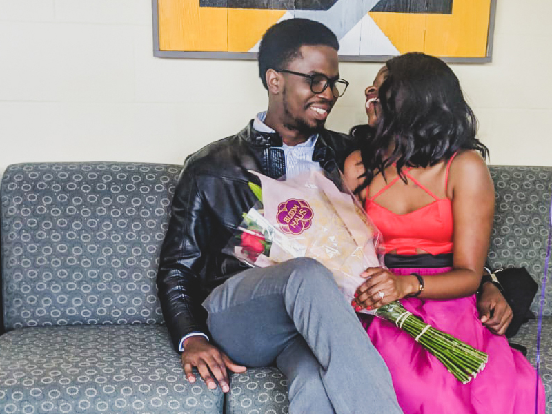 Students sitting on a couch after getting engaged