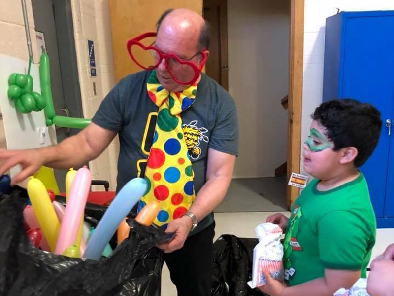 Rick Pappas teaches elementary school students using balloon animals