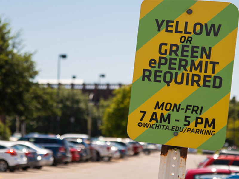 Green and yellow parking sign near Duerksen
