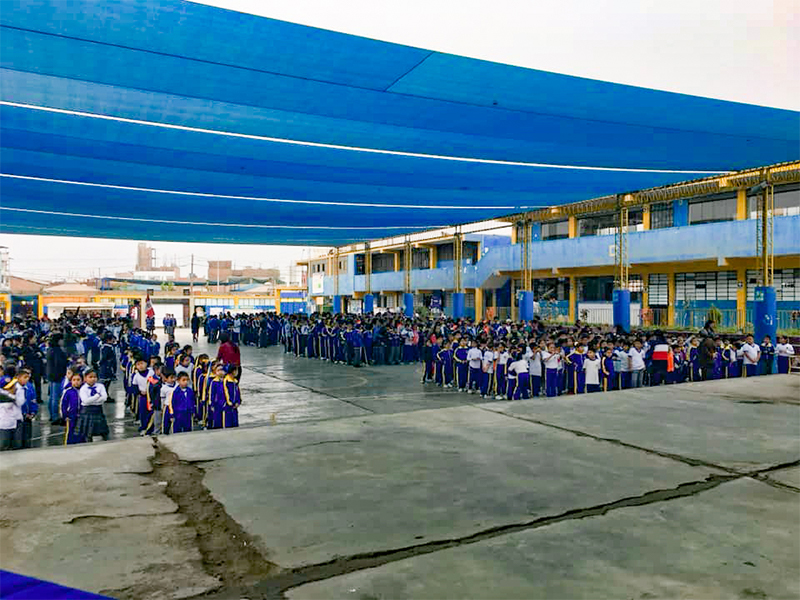 Elementary school students stand in a group during a performance.