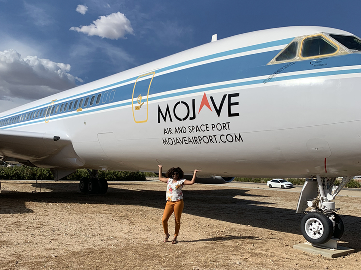 Khristian Jones stands in front of the Convair 990 jet parked in front of Mojave Air and Space port in California.