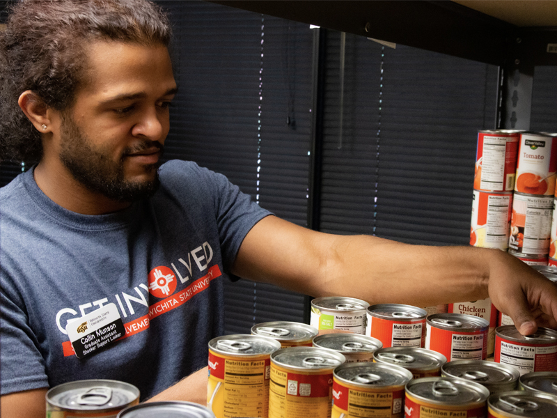 Collin Munson organizes cans inside the food locker.