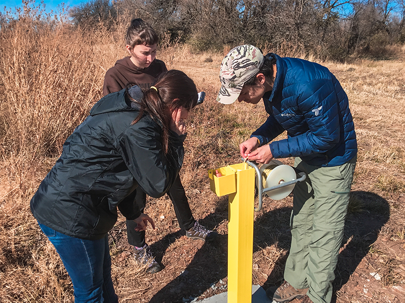 Students use a well at the new hydrogeology site