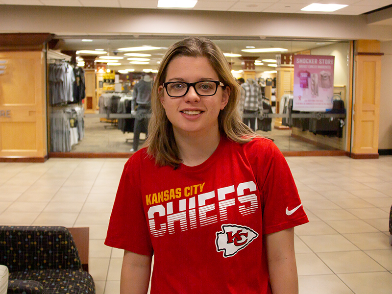 Natalie Dutton, a sport management student, shows off her Kansas City Chiefs gear.