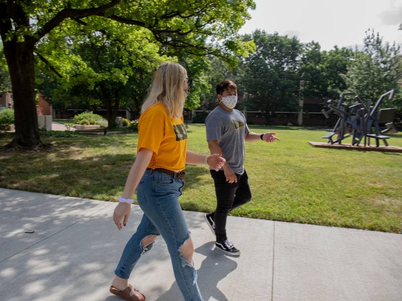Students walking with masks on campus
