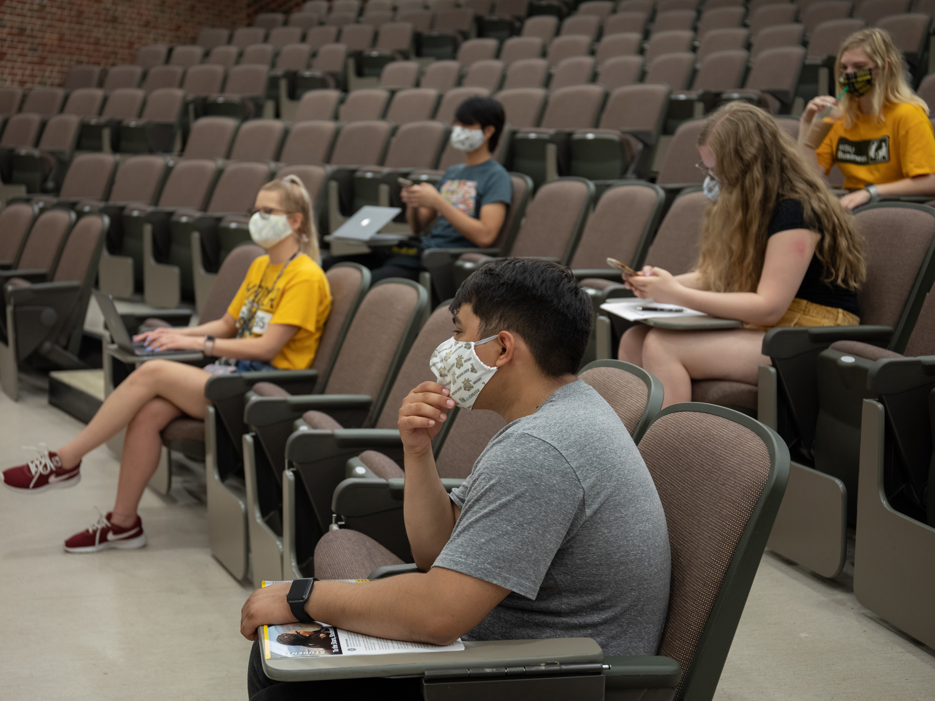 Students attend class wearing face coverings.