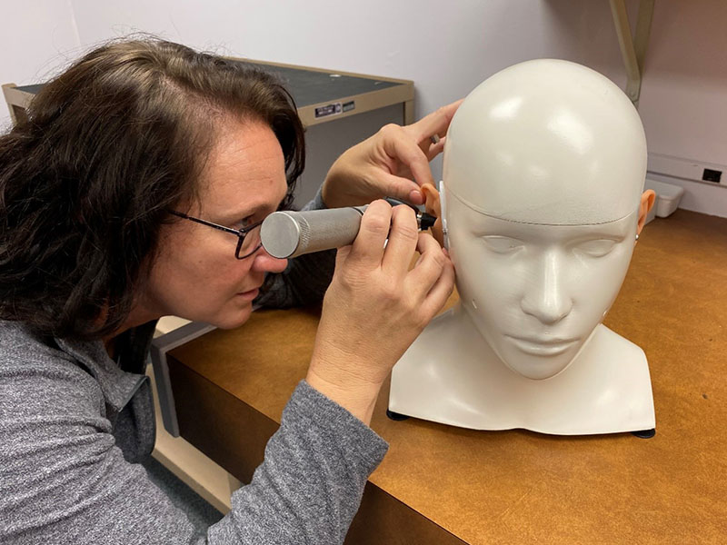 audiology student examines simulation manikin audiology student examines simulation manikin