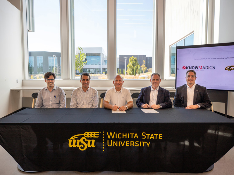 Wichita State and Knowmadics members sign the collaboration agreement