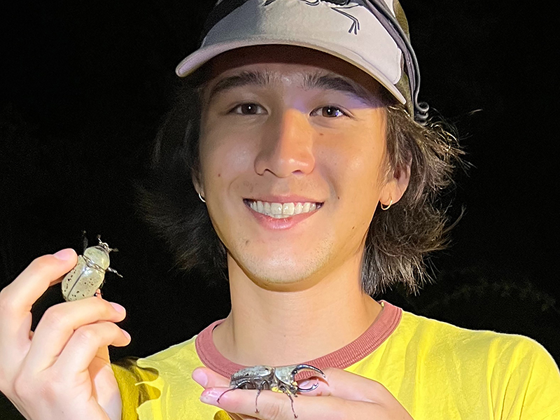 Max Proctor poses with two Hercules beetles