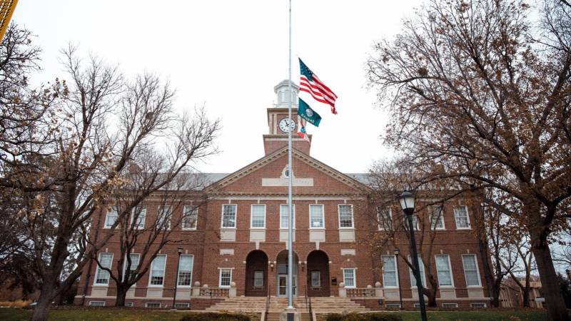 Morrison Hall with flags at half staff