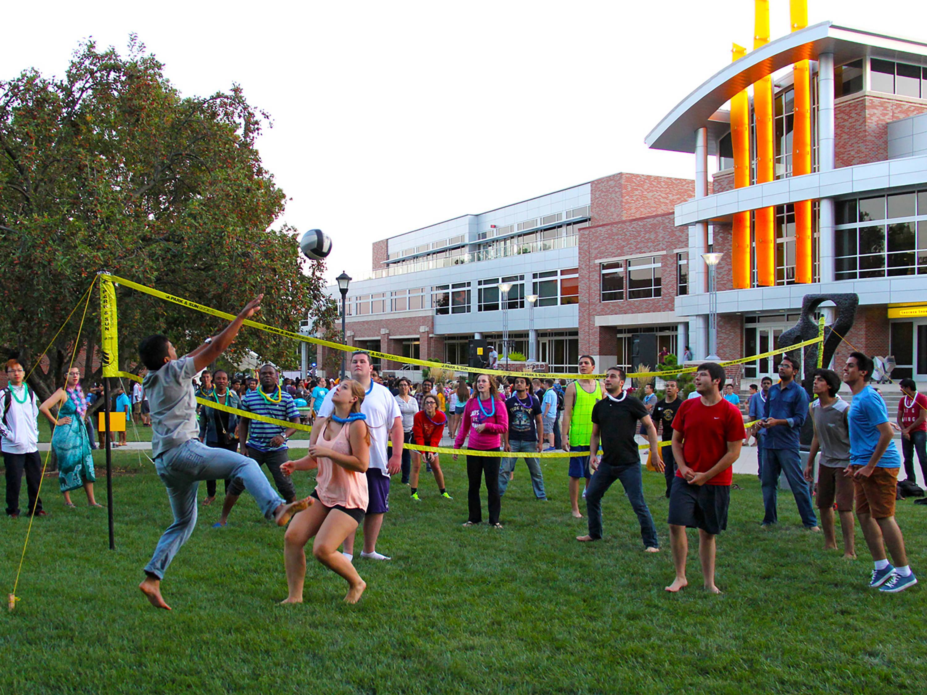 People playing volleyball in front of student center