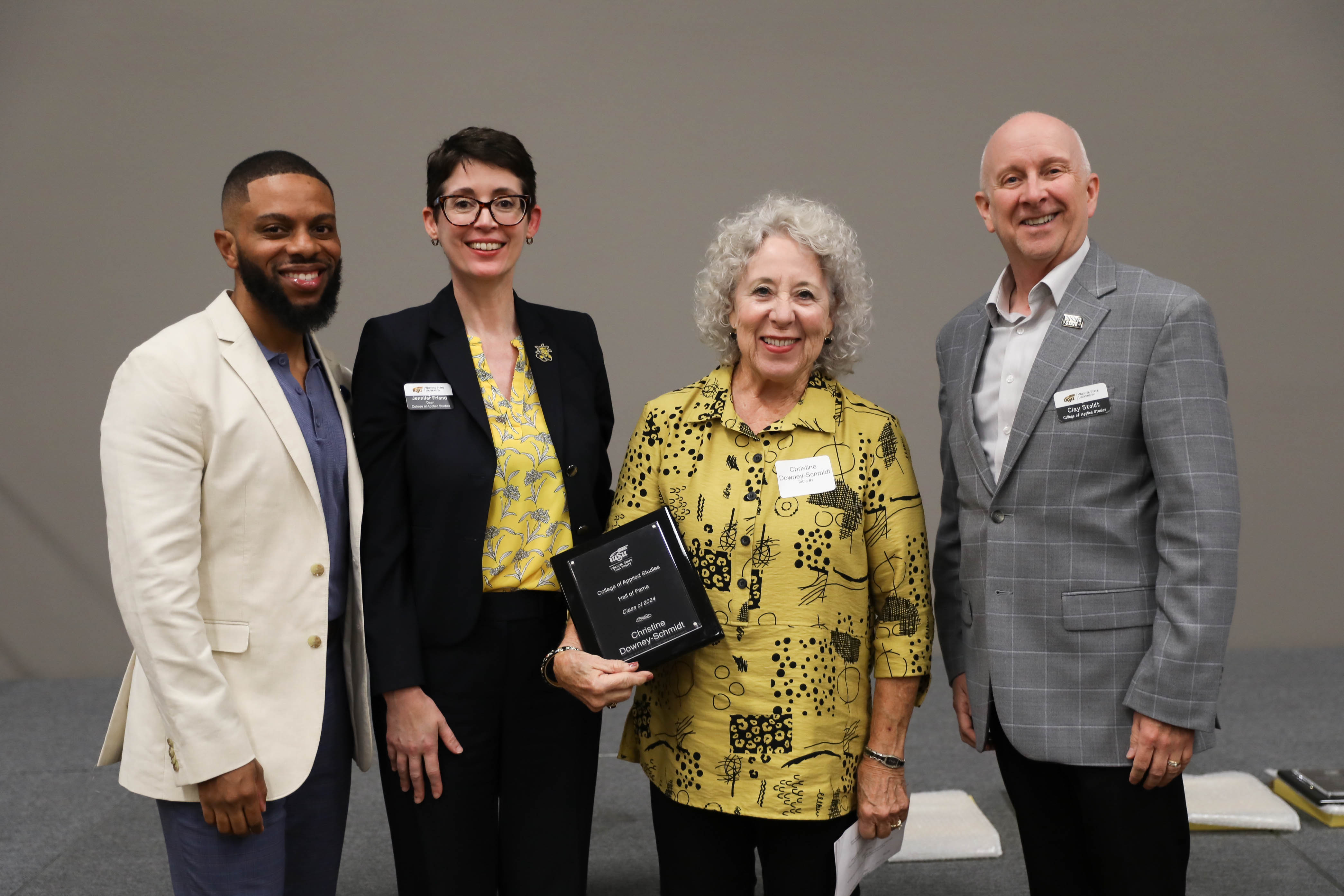 2024 CAS Hall of Fame Inductee, Christine Downey-Schmidt being recognized and receiving her award plaque alongside CAS Assistant Dean Dr. Bobby Berry, CAS Dean Dr. Jennifer Friend, and CAS Associate Dean, Dr. Clay Stoldt at the Hall of Fame Induction Ceremony