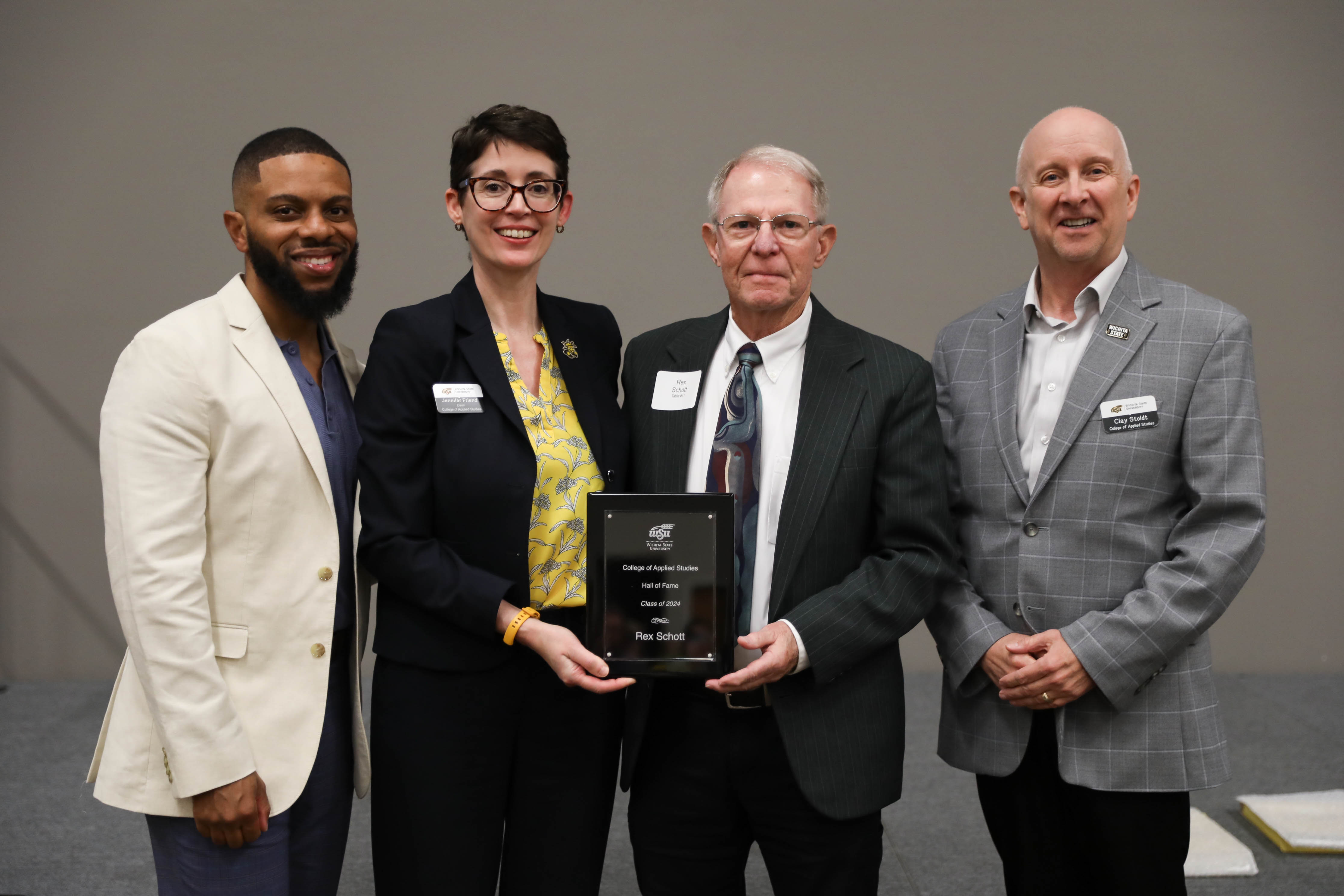 2024 CAS Hall of Fame Inductee, Rex Schott being recognized and receiving her award plaque alongside CAS Assistant Dean Dr. Bobby Berry, CAS Dean Dr. Jennifer Friend, and CAS Associate Dean, Dr. Clay Stoldt at the Hall of Fame Induction Ceremony