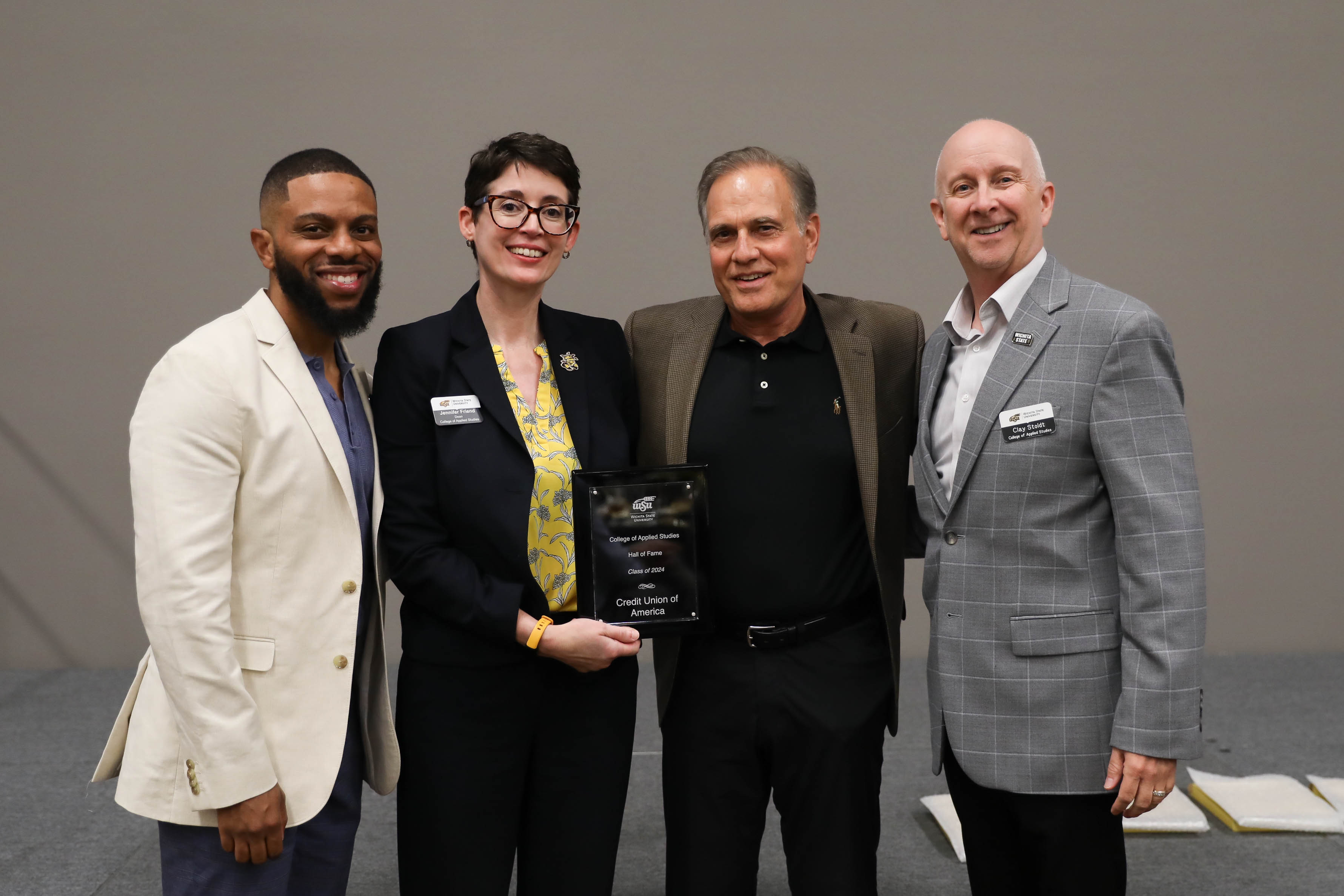 2024 CAS Hall of Fame Inductee, Credit Union of America representative Frank Shoffner, president and CEO of CUA being recognized and receiving her award plaque alongside CAS Assistant Dean Dr. Bobby Berry, CAS Dean Dr. Jennifer Friend, and CAS Associate Dean, Dr. Clay Stoldt at the Hall of Fame Induction Ceremony