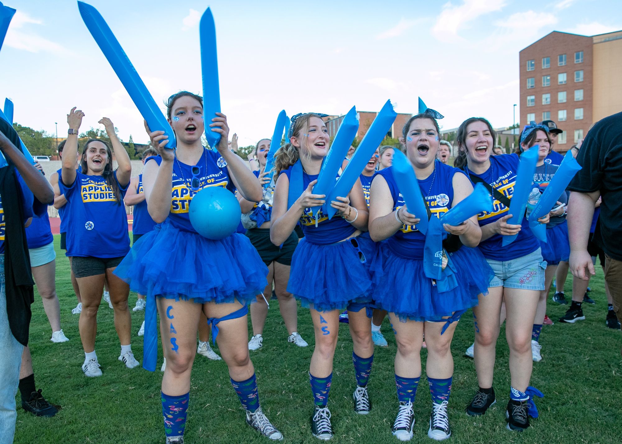 Clash of the Colleges Clash of the colleges - students with swag gear cheering dressed in CAS blue tshirts
