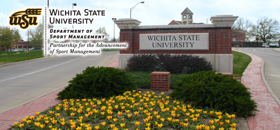 Photo of a bed of blooming tulips in front of one of the WIchita State University entrance signs. 