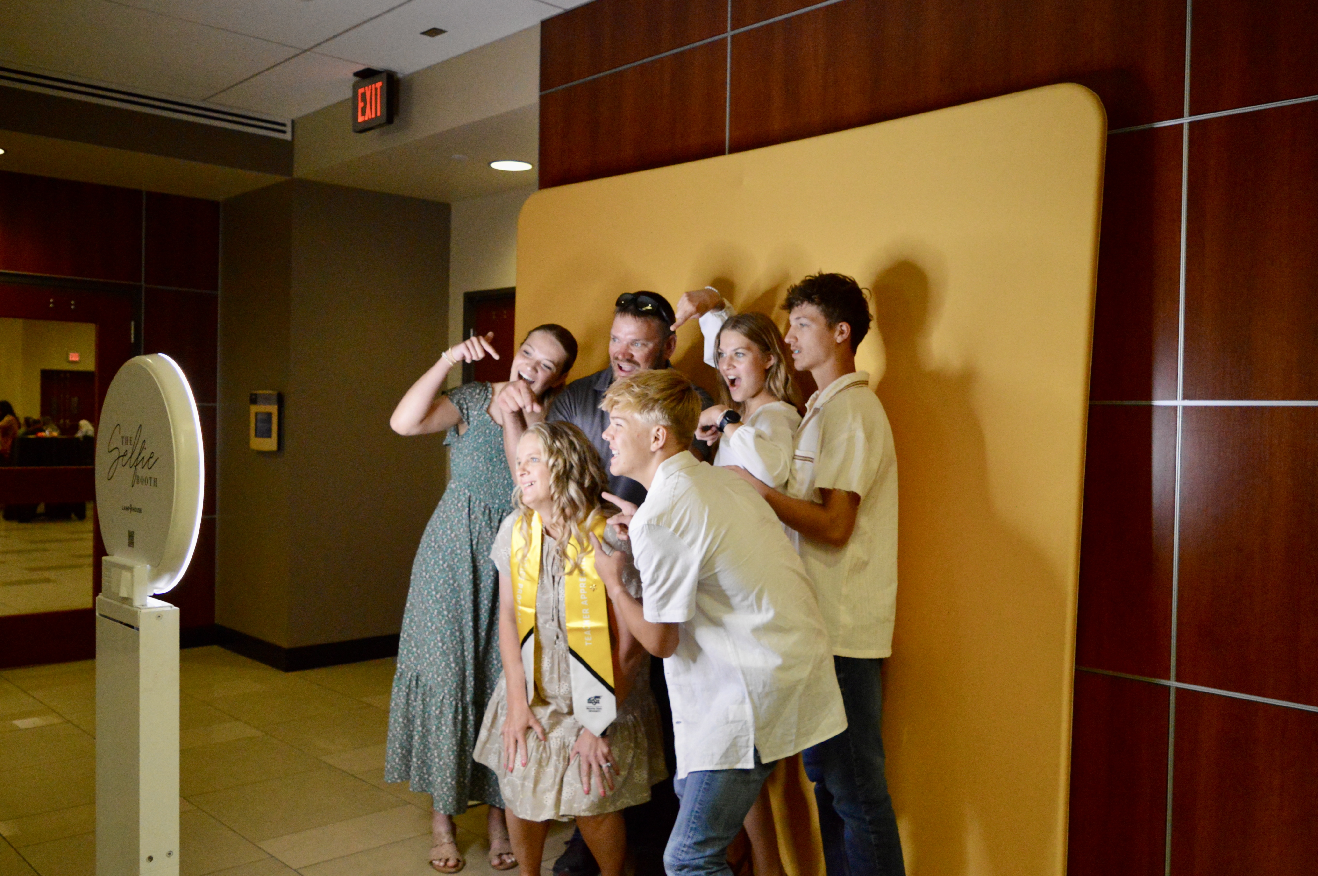 Graduate with family using backdrop