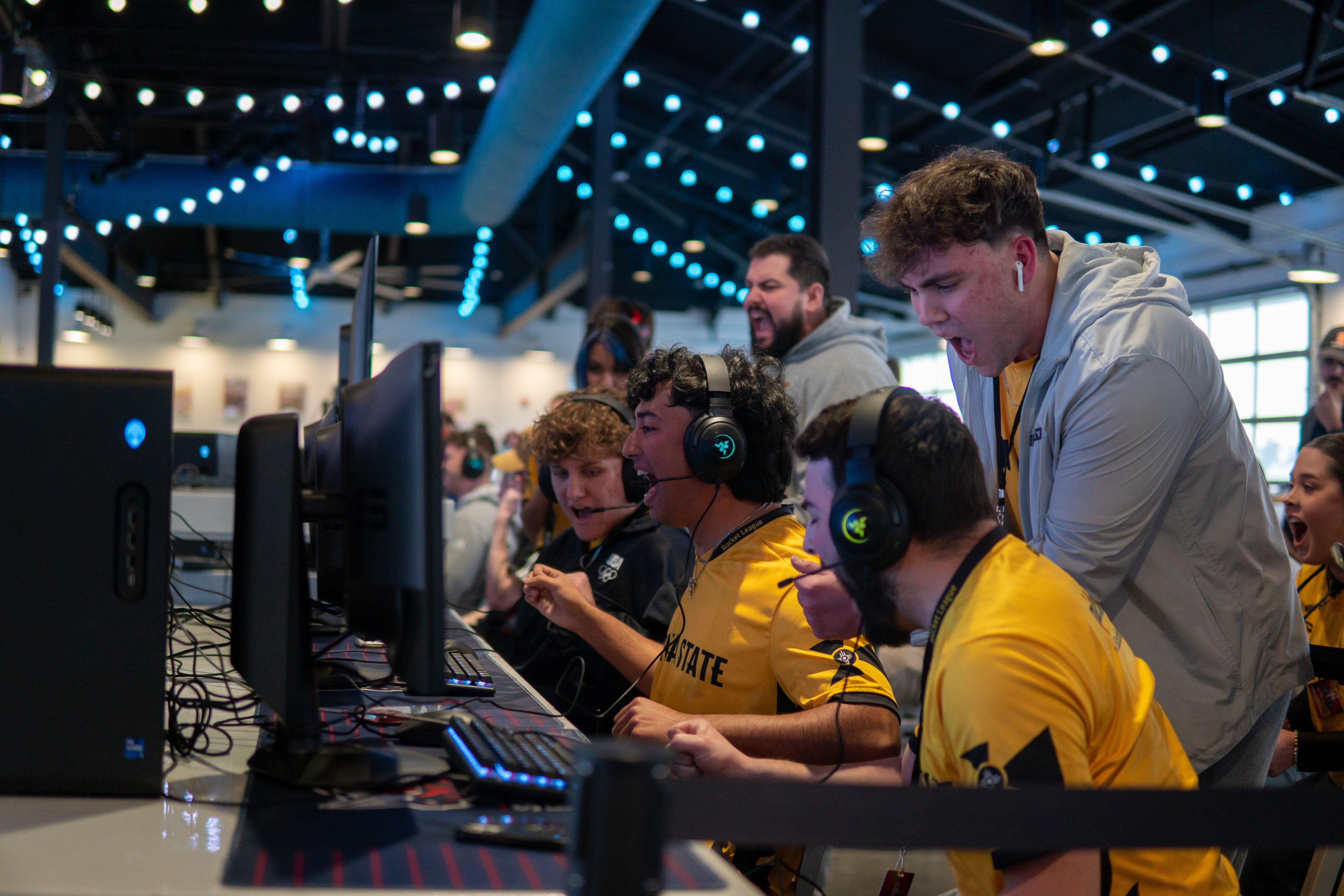 Wichita State Esports Wichita State Esports players celebrate during a competitive gaming match in front of computer monitors