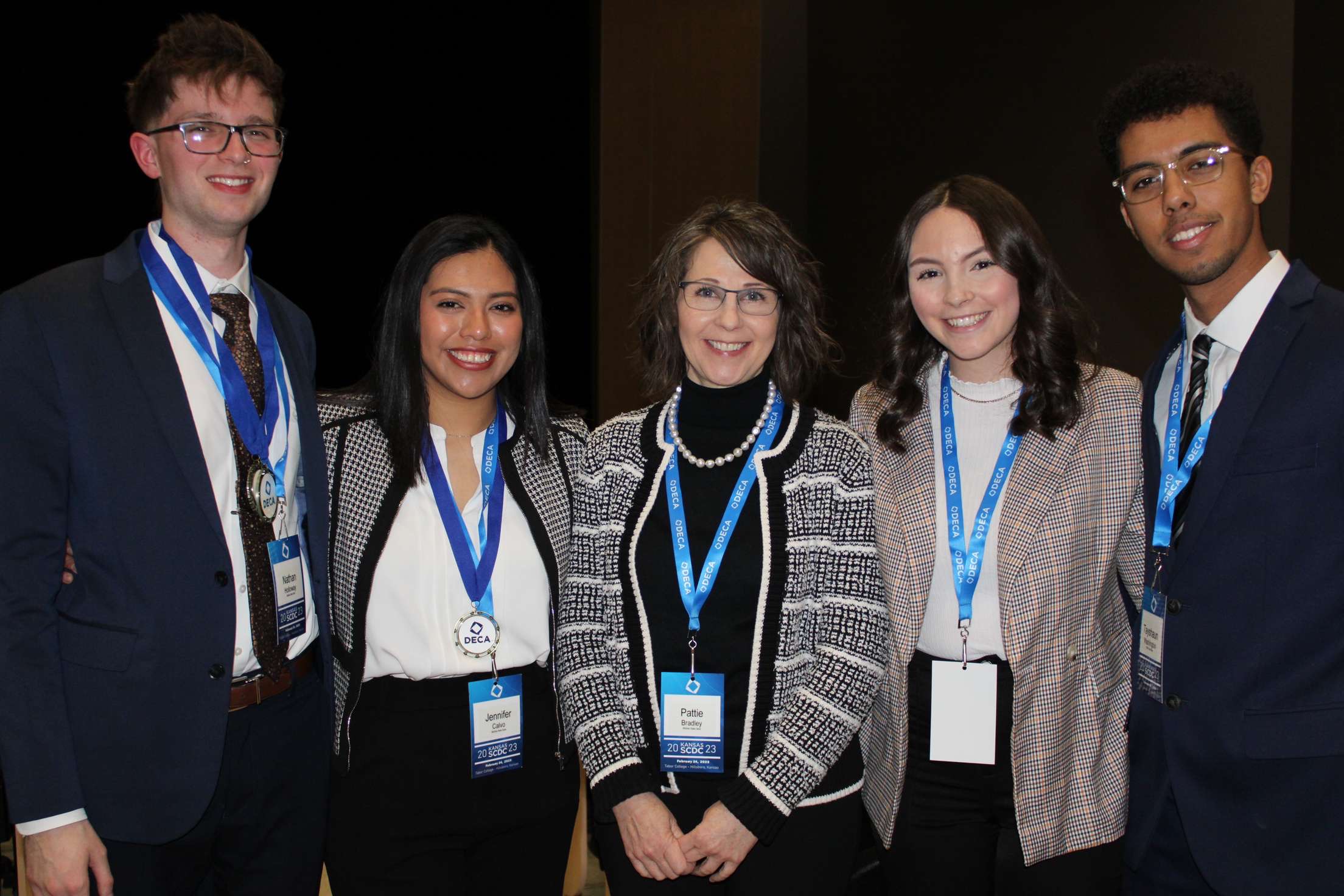 Collegiate DECA Wichita State students with sponsor Pattie Bradley at State Competition
