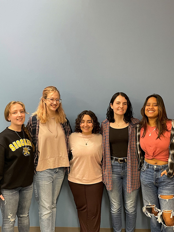 The team behind XX Menstrual Monitoring standing in front of a blue backdrop