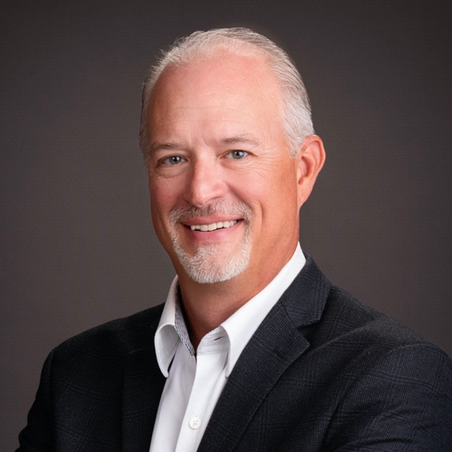 Chase Curtiss sitting on a chair in front of a plain background.