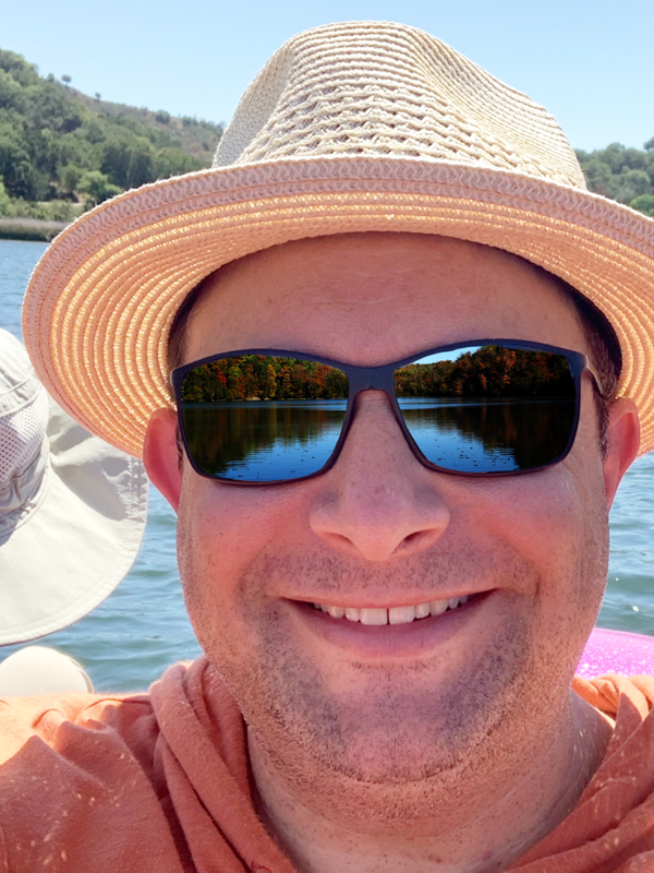 A headshot of Jeremy Conescu on a boat.