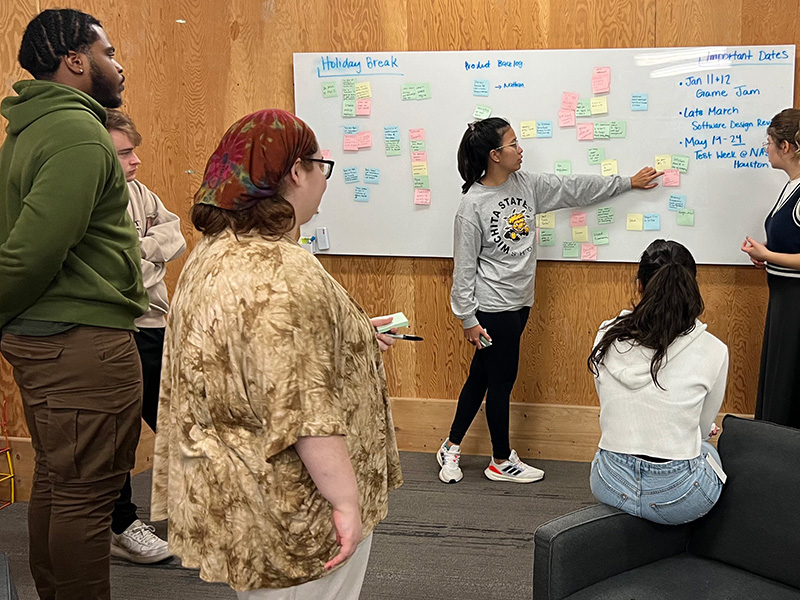 Desmond Cockrell, Yumi Kikuchi, and team working on design thinking methods