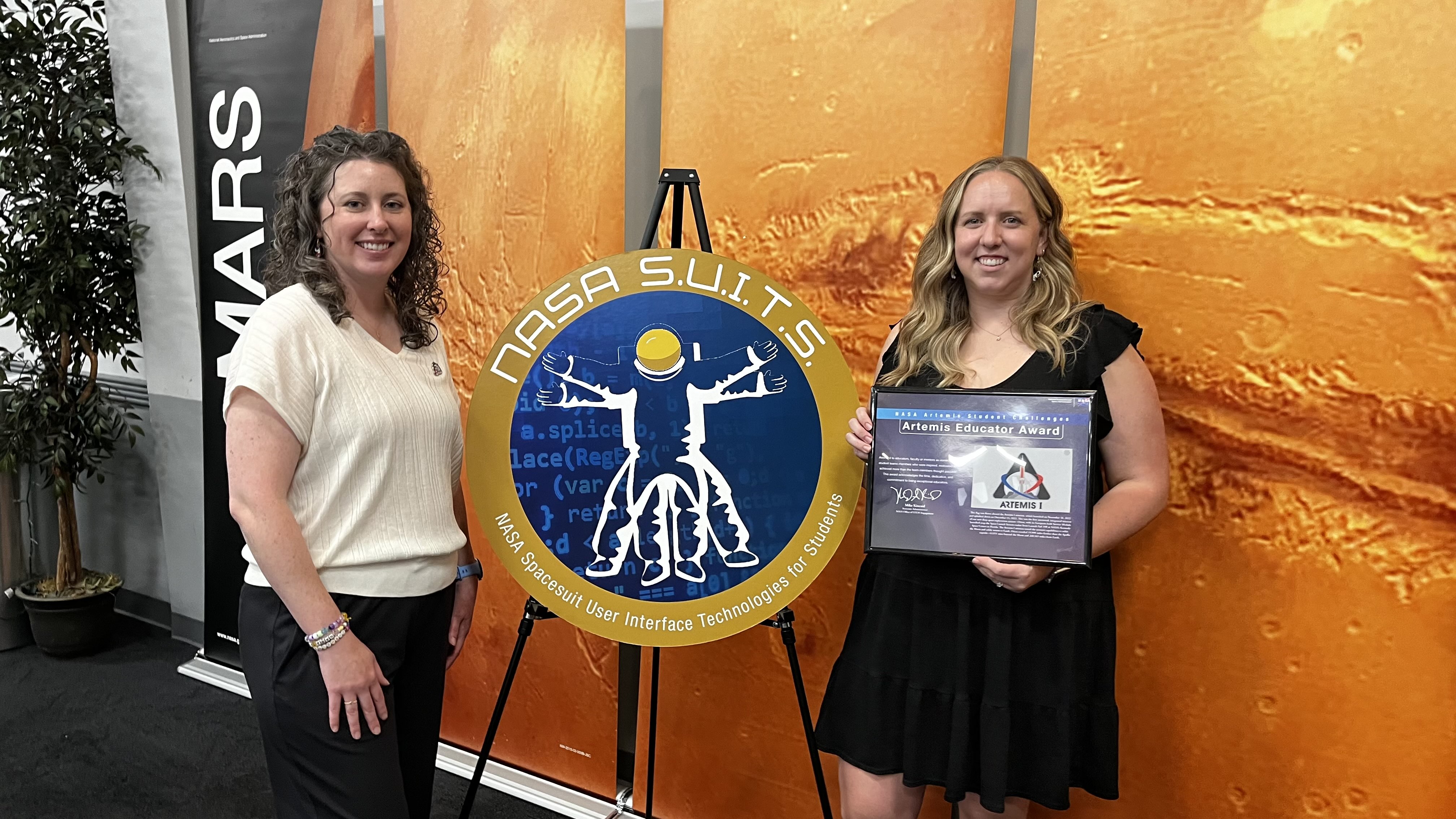 Maggie Schoonover and Kristyn Waits holding her Artemis Educator award