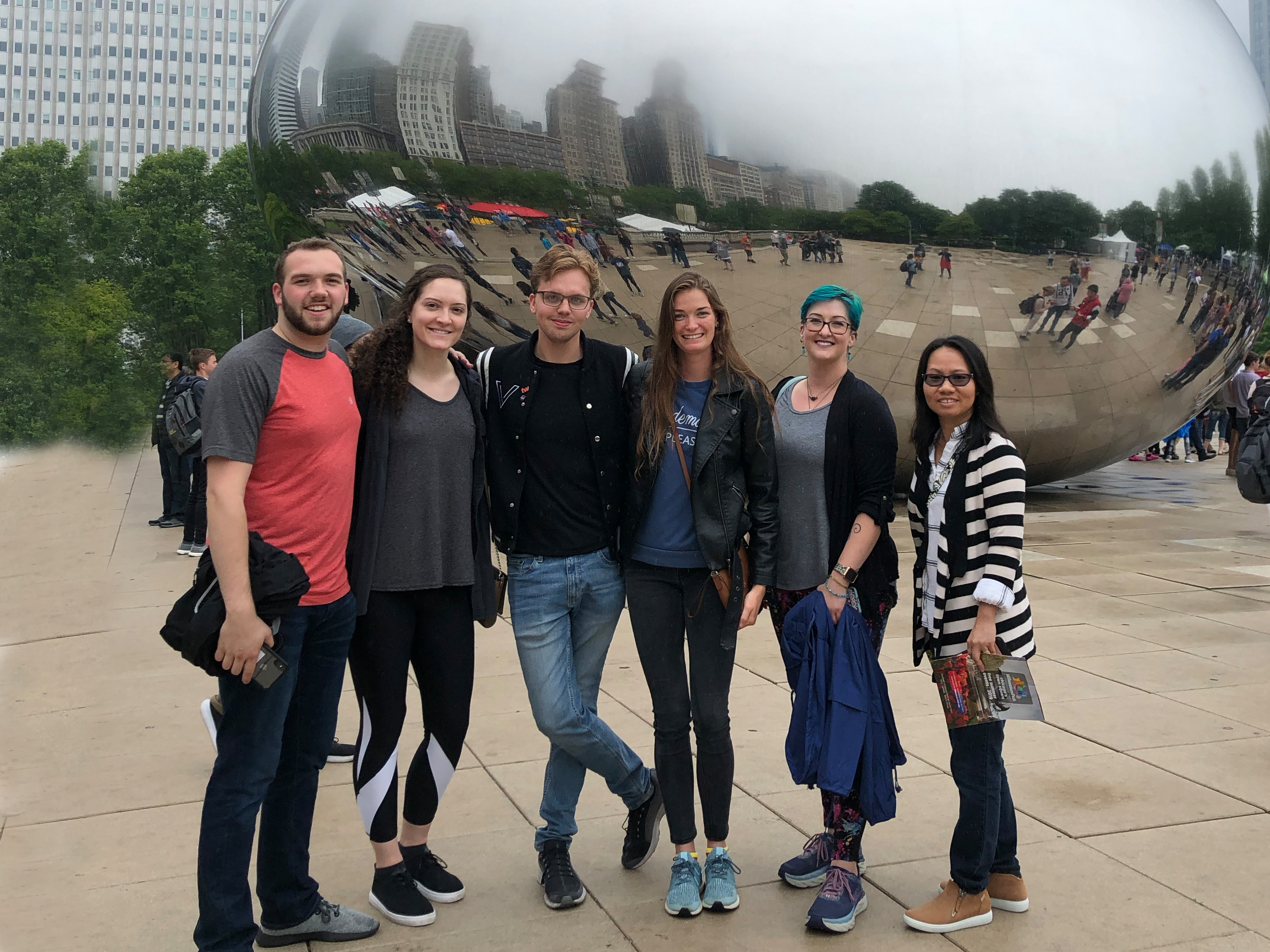 Six Master's of Innovation Design students pose for photo in front of The Bean in Chicago
