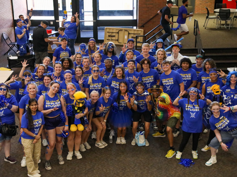 College of Education students during Clash of the Colleges in blue shirts gathered as a group