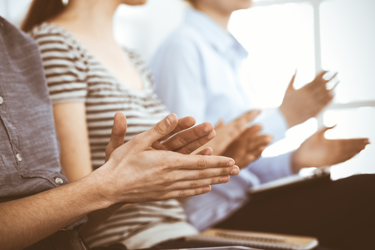 Audience clapping for award recipients