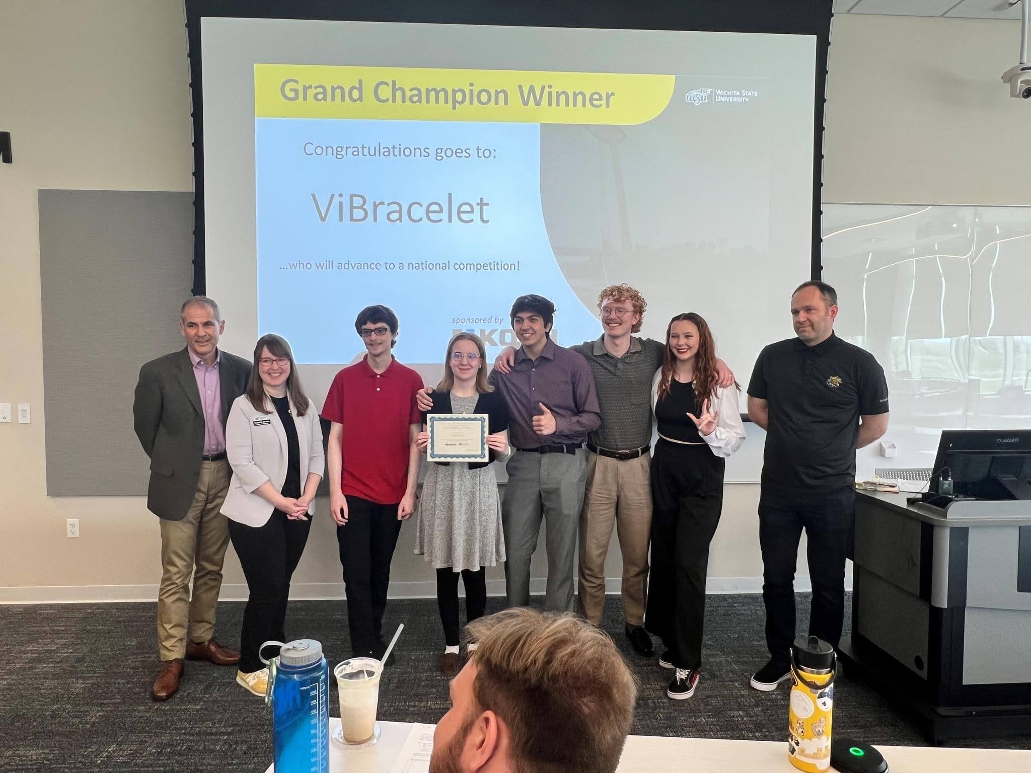 Photo of the ViBracelet winning team with members posing for a photo with the dean and faculty advisors.