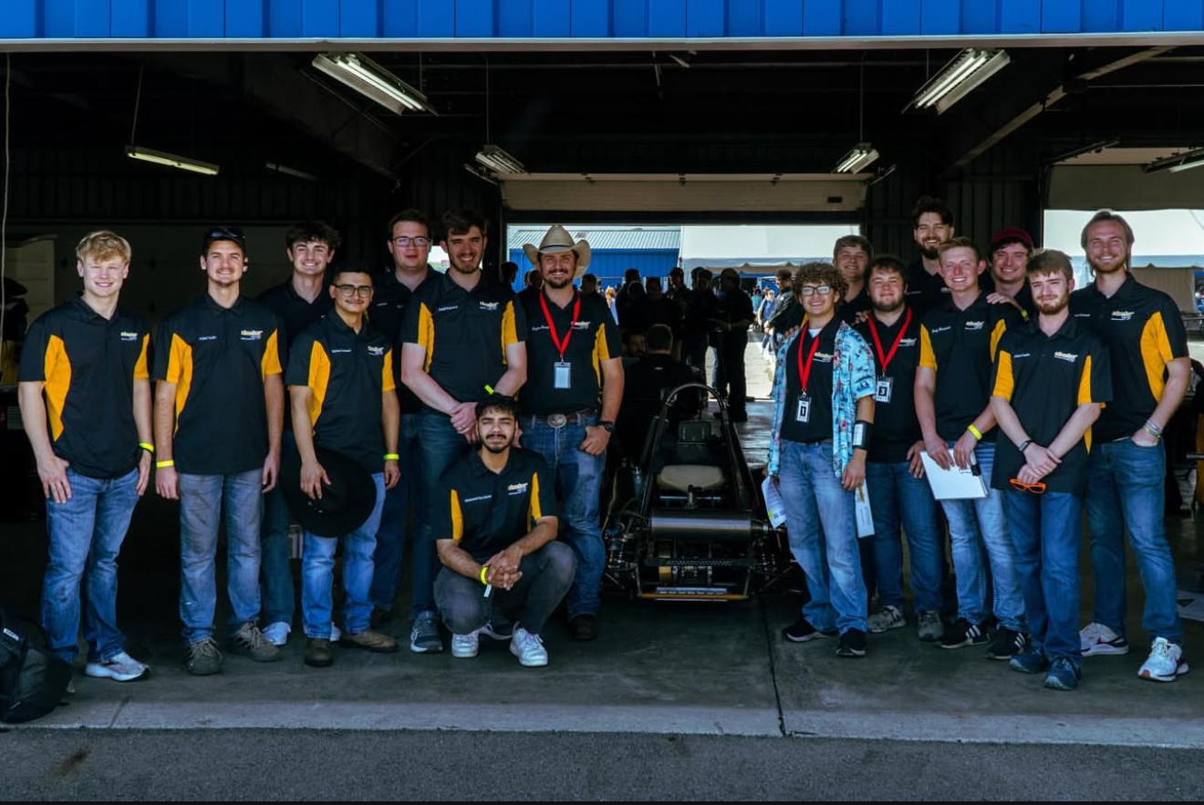 SR25 Team standing behing car in garage