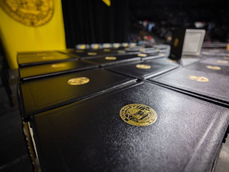 Diplomas displayed on a table during Fall Commencement 2021