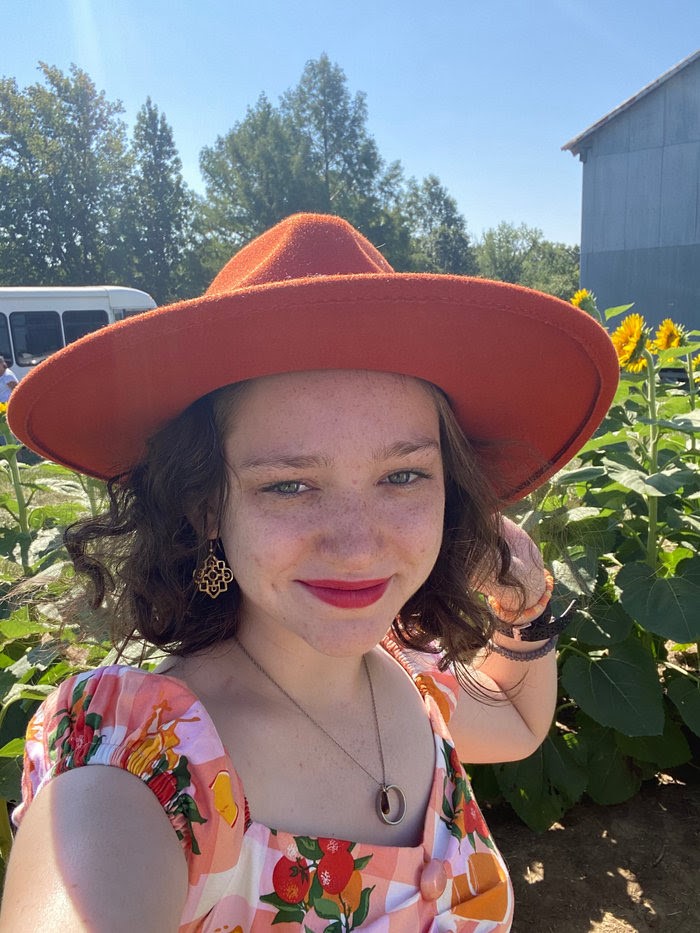 white woman in a wide brimmed hat