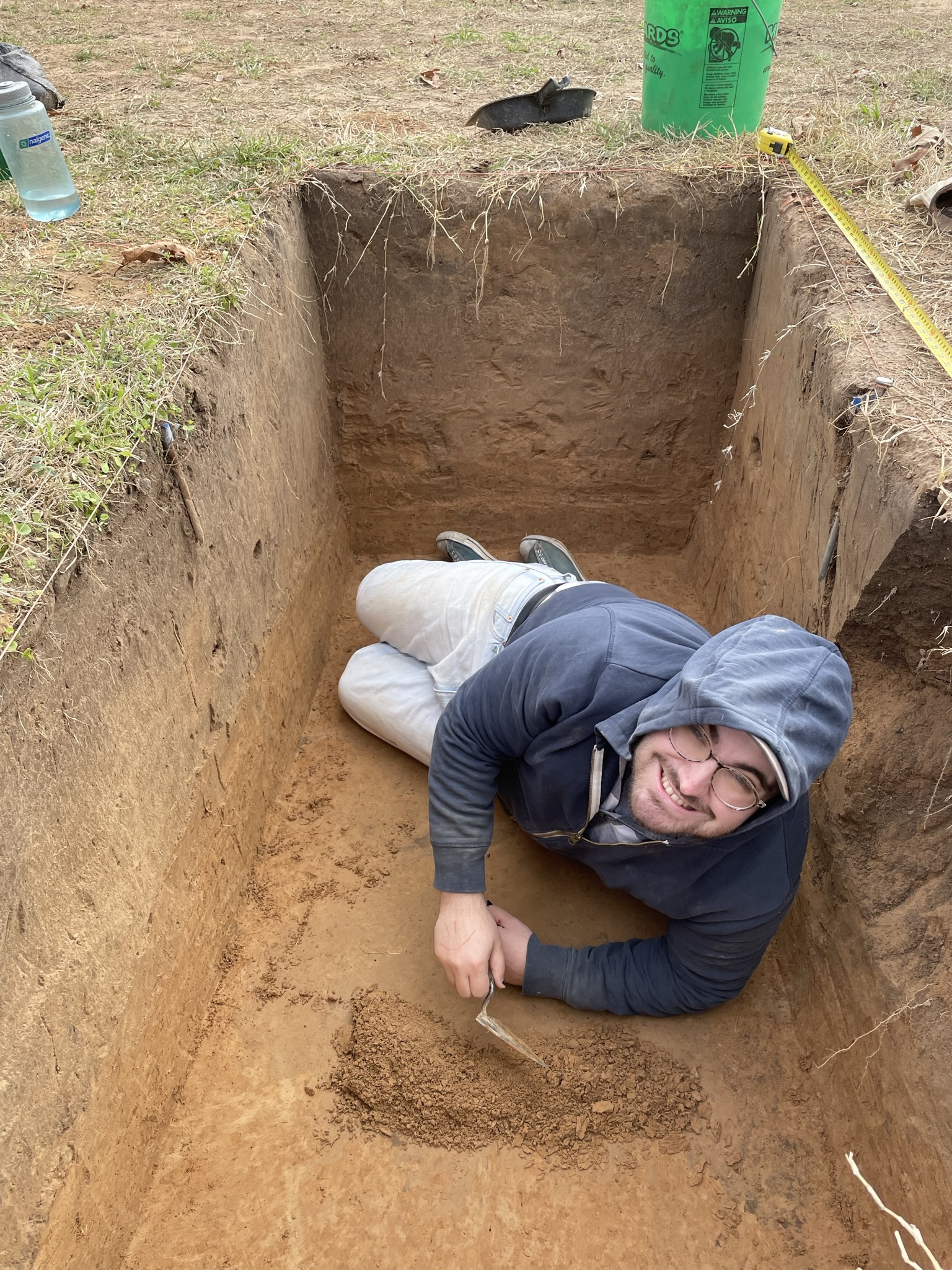 man in square hole digging