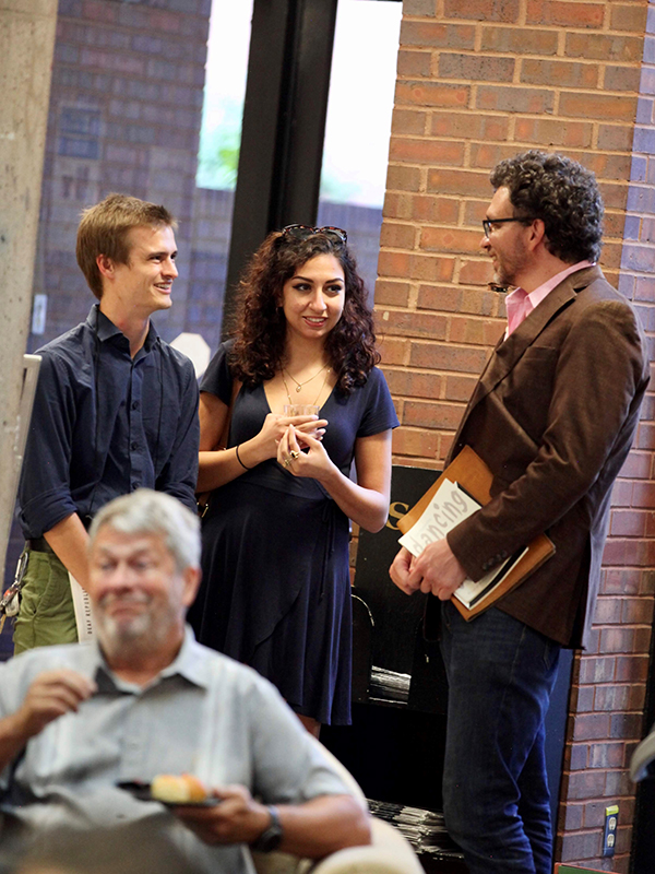 Creative Writing students converse with a faculty member at an event