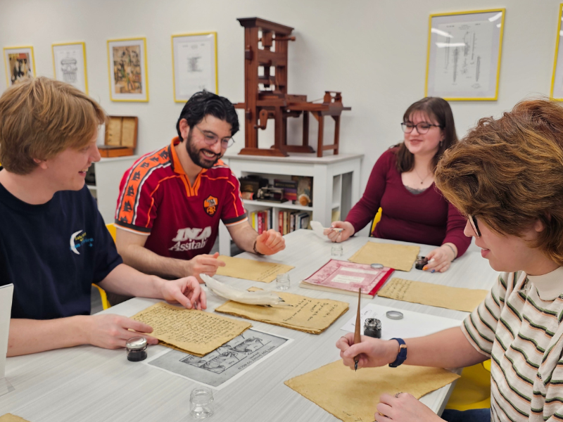 WSU students practice manuscript writing with quills. WSU students pratice manuscript writing with quills