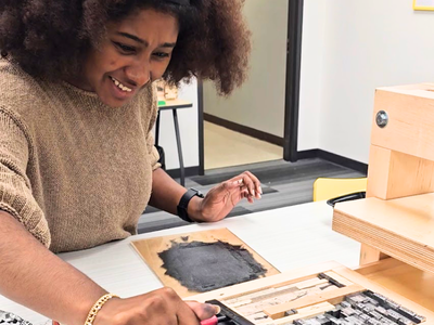 Zariah inking type in the letterpress Zariah inks up type in the letterpress