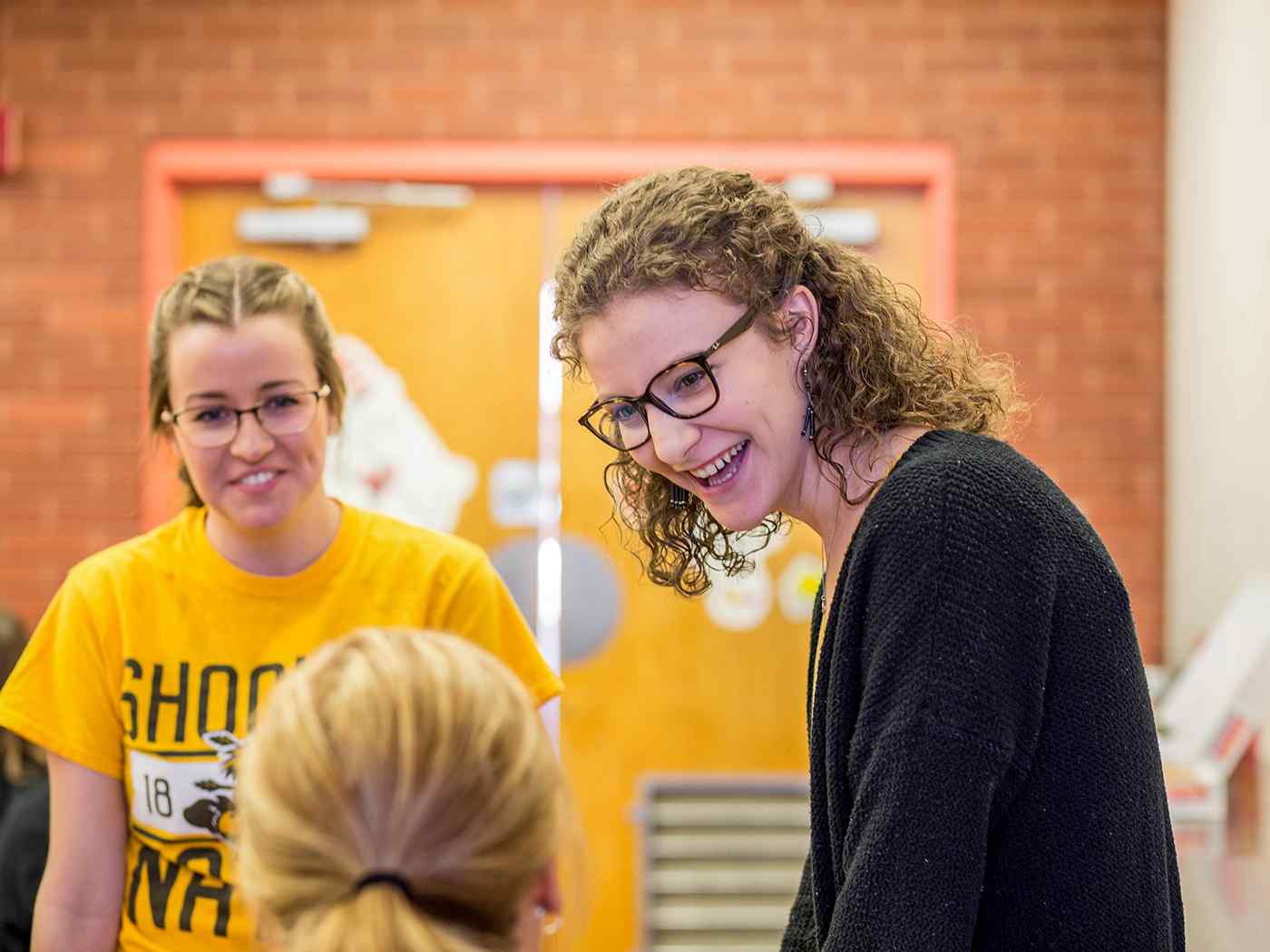 Students discuss an assignment with a professor