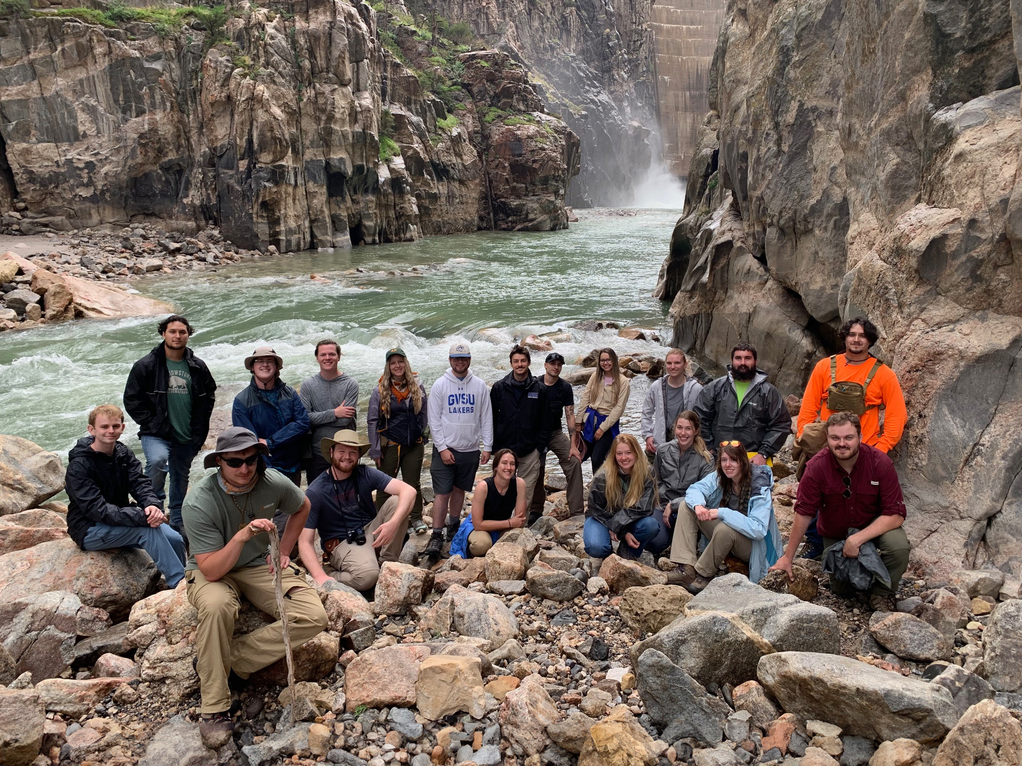 girl writing notes on rock