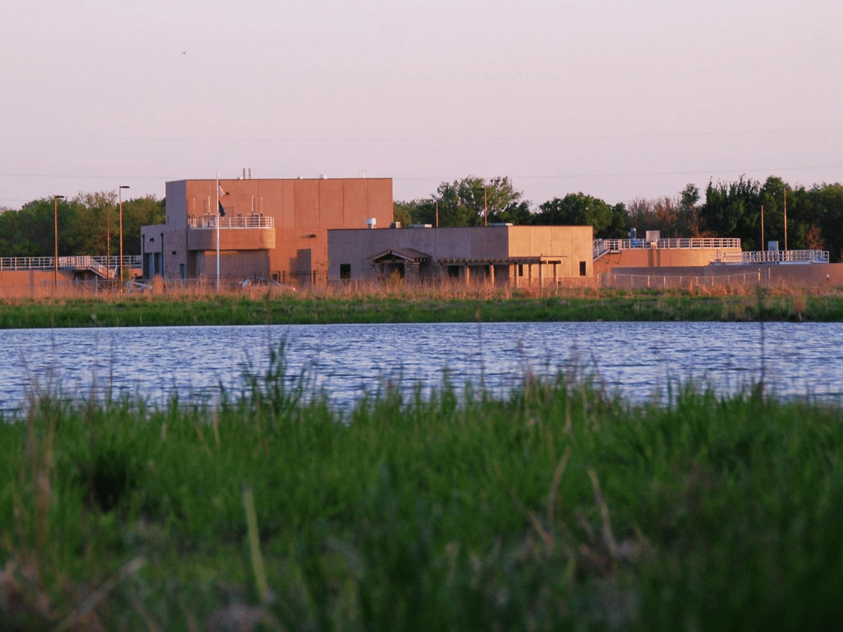 Wetlands, water resevoir and City of El Dorado’s Wetlands and Water Reclamation facility in background at sunset.