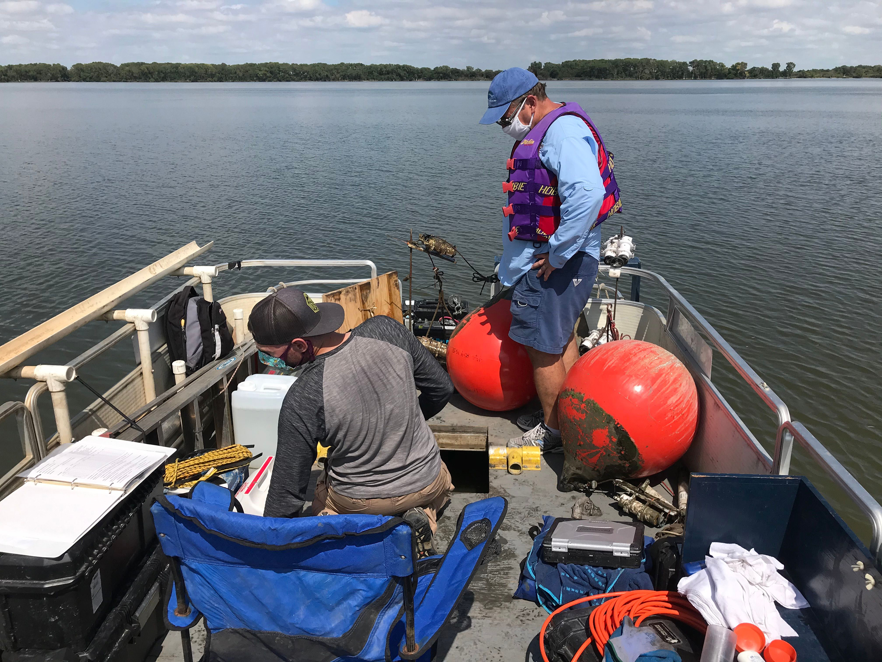 KU researchers test for blue-green algae levels at Marion Lake.