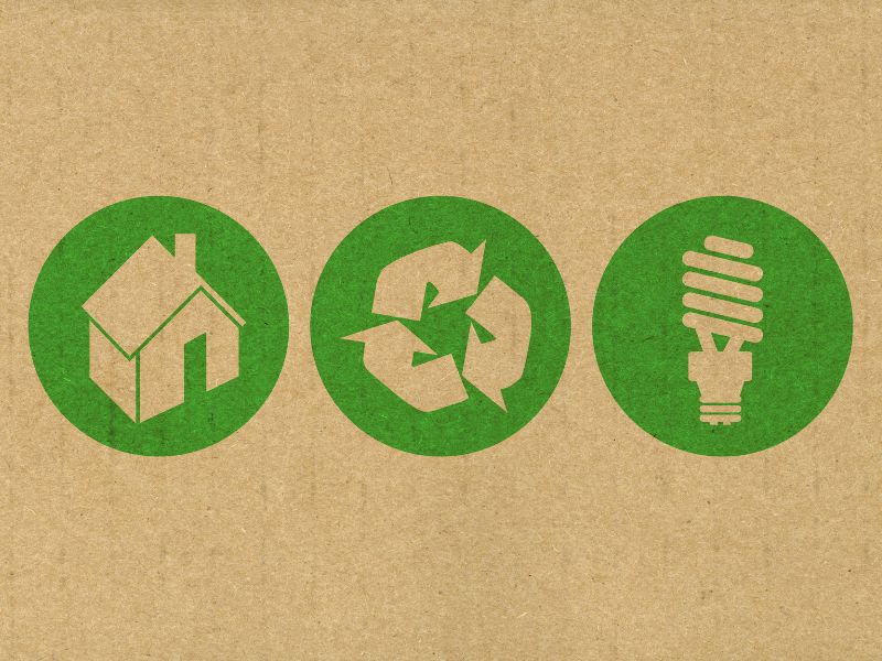 recycled paper with green stamp illustrations of a home, a recycle icon and an LED lightbulb