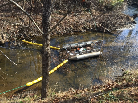 A “Trash Trout” trash trap floats on Deer Creek in Deer Creek Park in Maplewood, Missouri. 