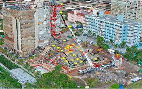 Image of one tower standing, one tower collapsed