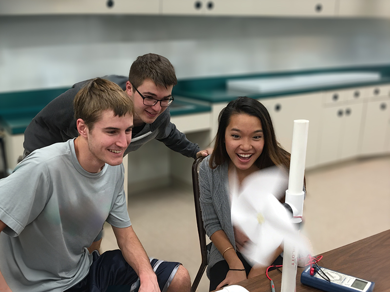 Three students work in a lab