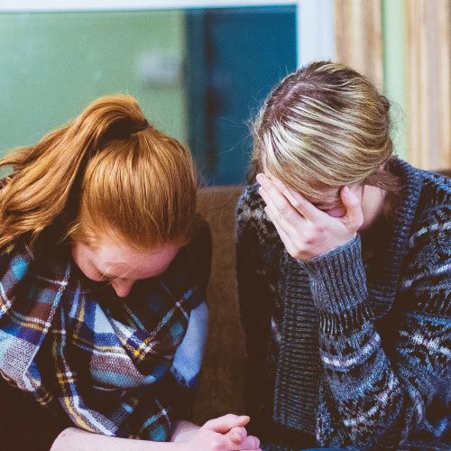 two individuals consoling each other