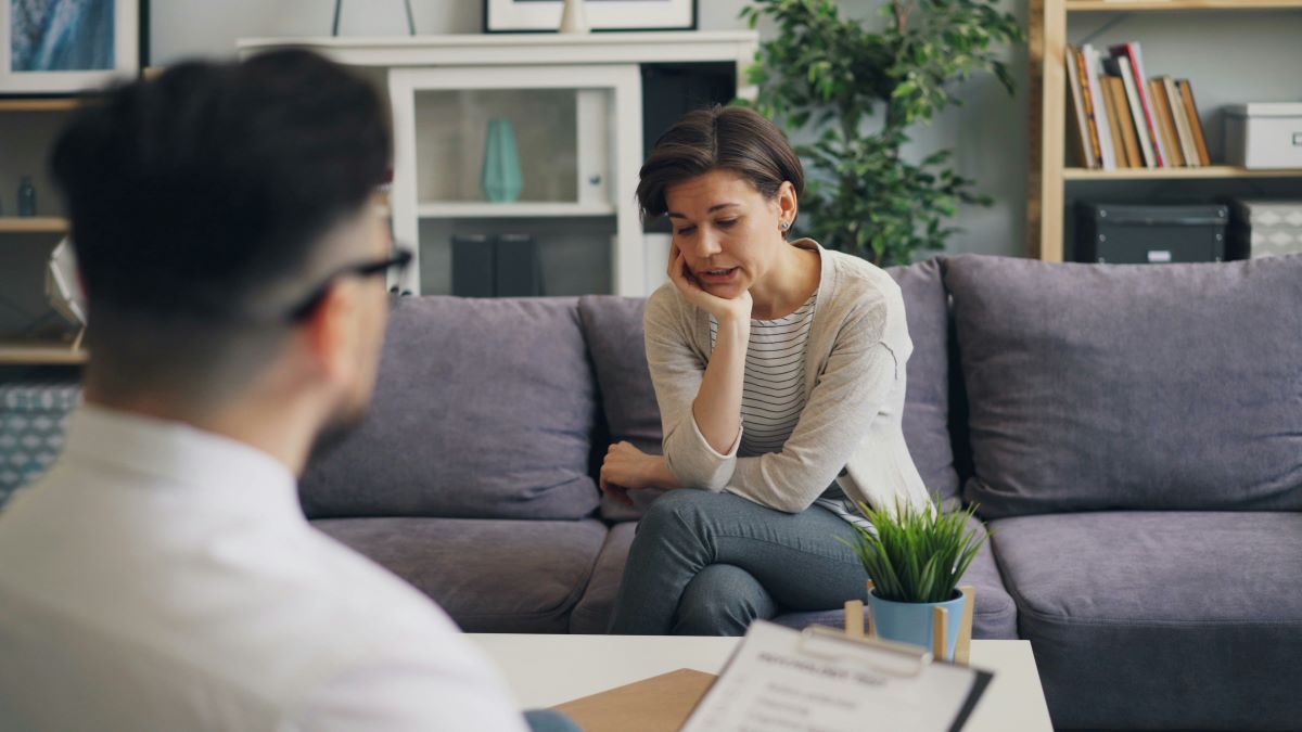 A woman speaking in a therapy room